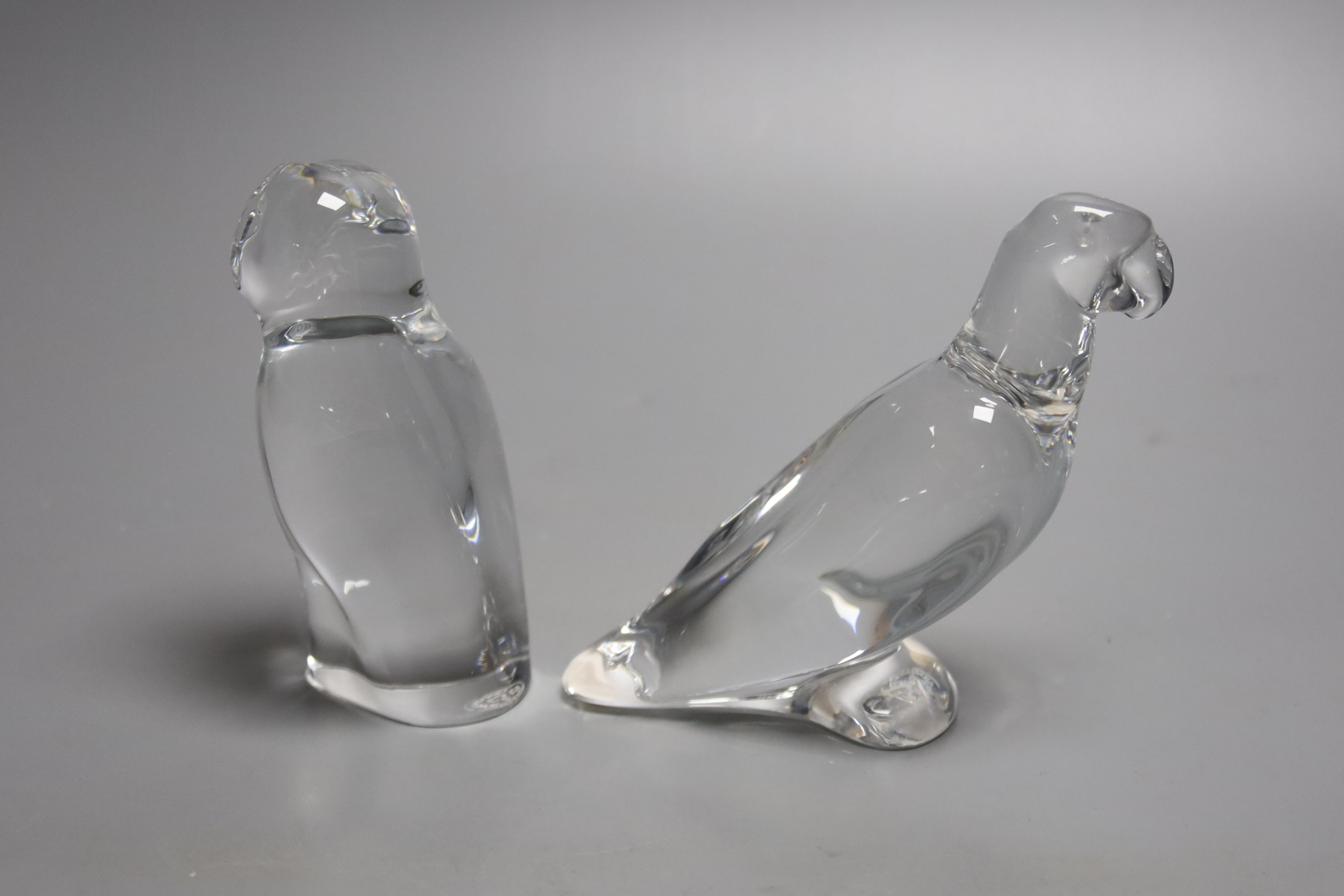 A Baccarat crystal figure of a barn owl, 10cm high, together with a Baccarat crystal figure of a parrot, 10cm high